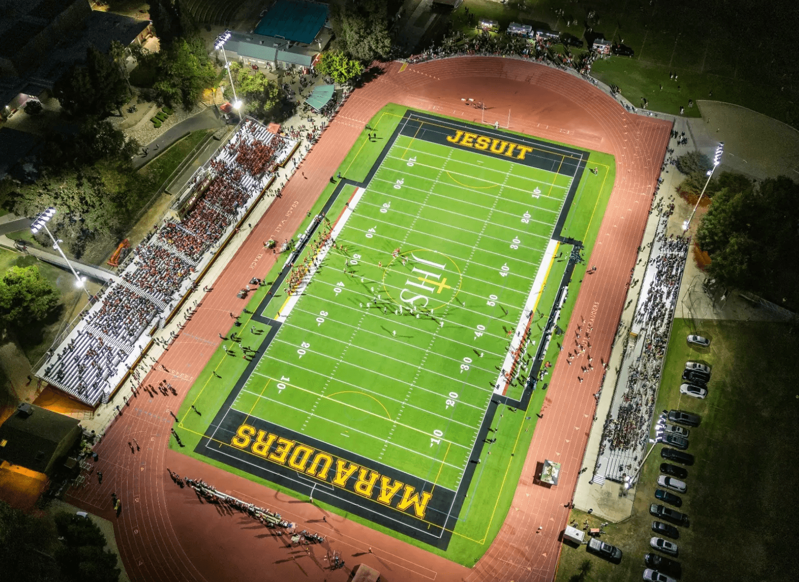 Aerial view of a night football game at Jesuit High School.