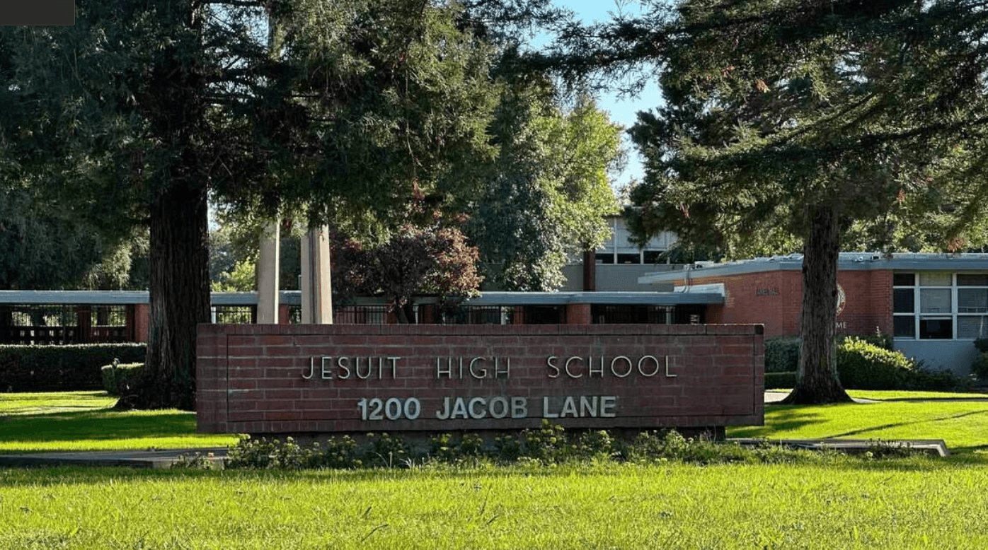 The brick entrance sign at 1200 Jacob Lane reading Jesuit High School.