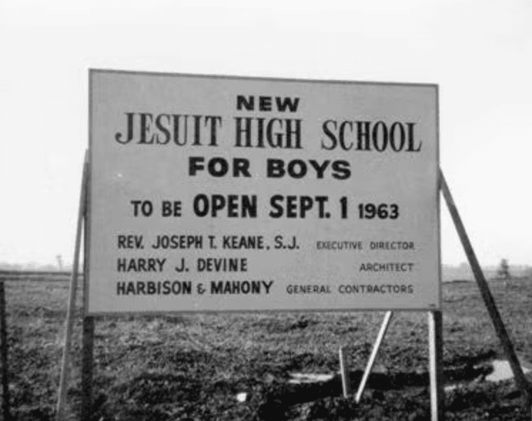 Construction sign at the future site of Jesuit High School, reading "New Jesuit High School for Boys, to be open Sept. 1, 1963."